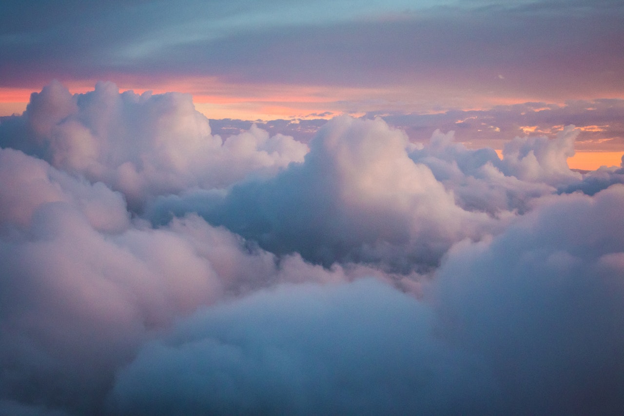 Gorgeous clouds in a pink, purple and orange sky, used to represent cloud computing solutions.